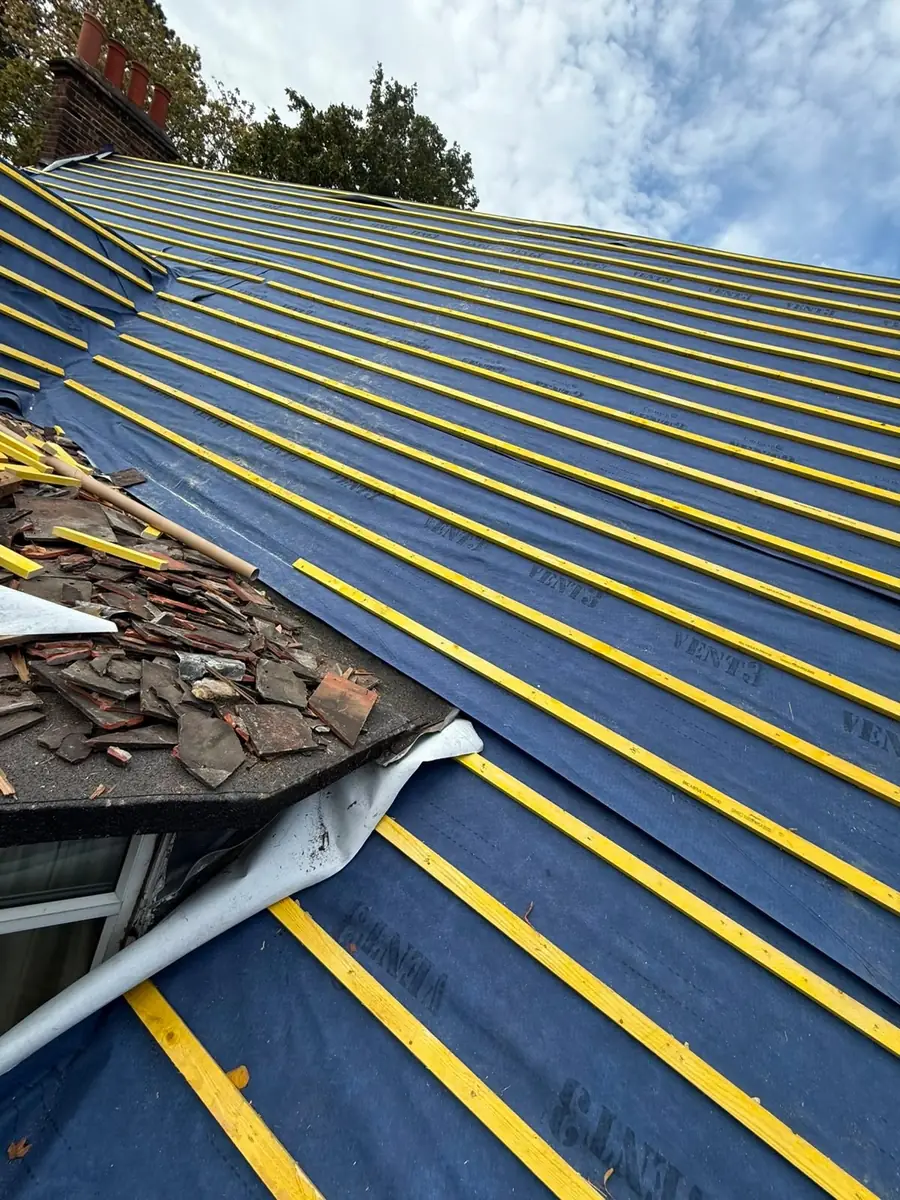 New battens with slates stacked ready to lay