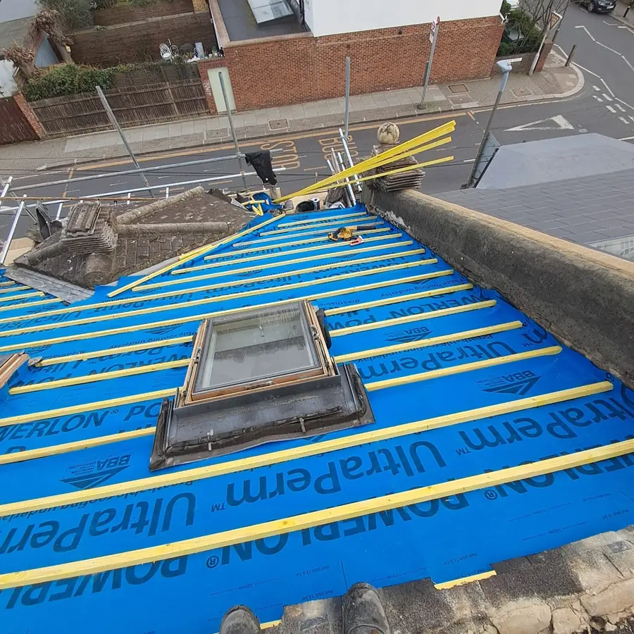 Blue breathable membrane and battens round a new roof window