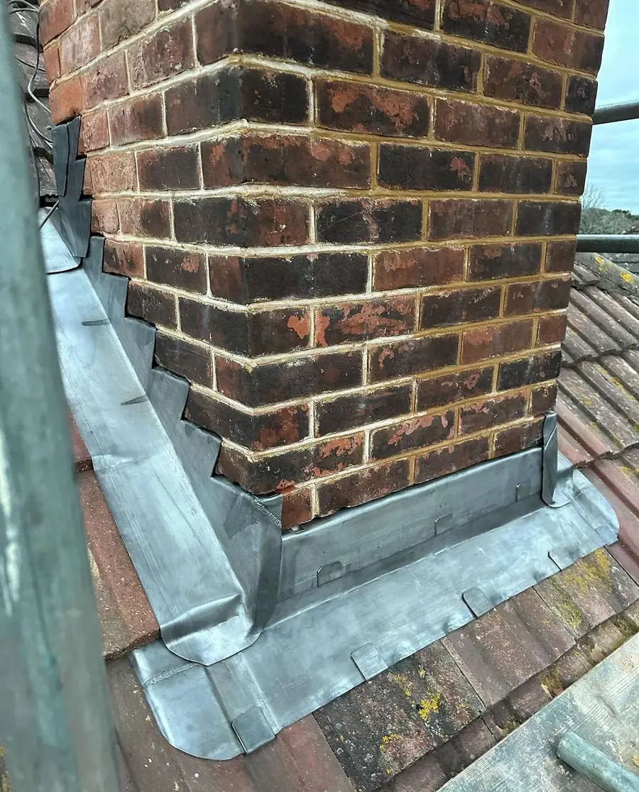 New lead flashing dressed round a brick chimney
