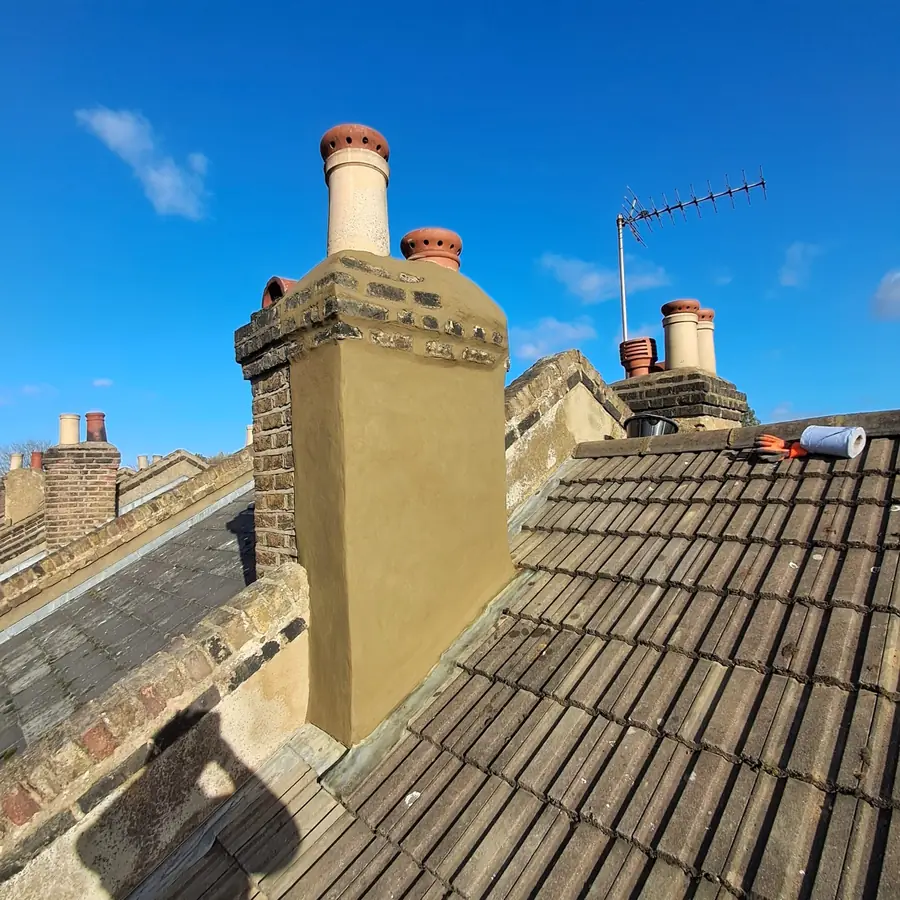 Rendered chimney stack on a tiled roof