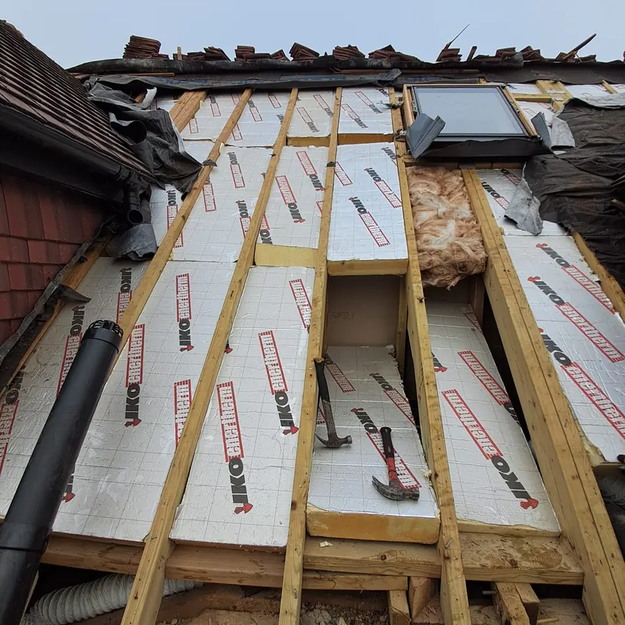 Insulation boards fitted between the rafters of a dormer