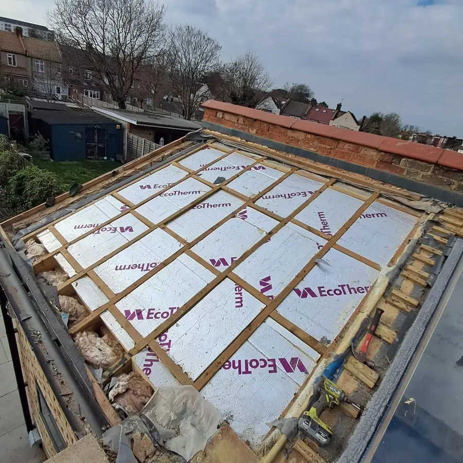 Insulation boards fitted between flat roof joists