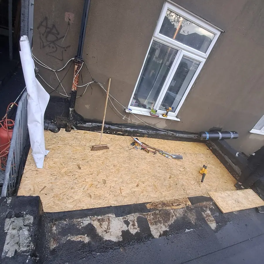 OSB deck on a flat roof beside a dormer window