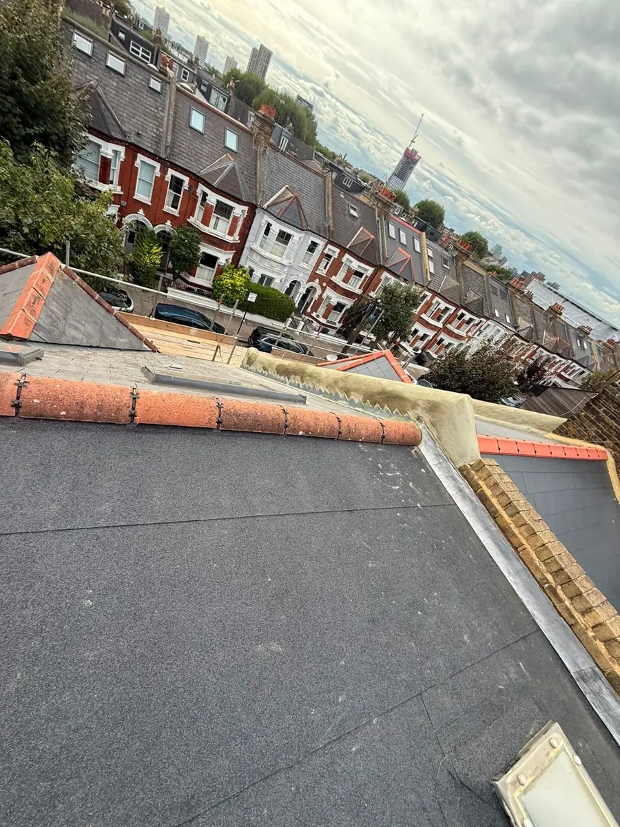 Finished flat roof beside an orange ridge, terraces behind