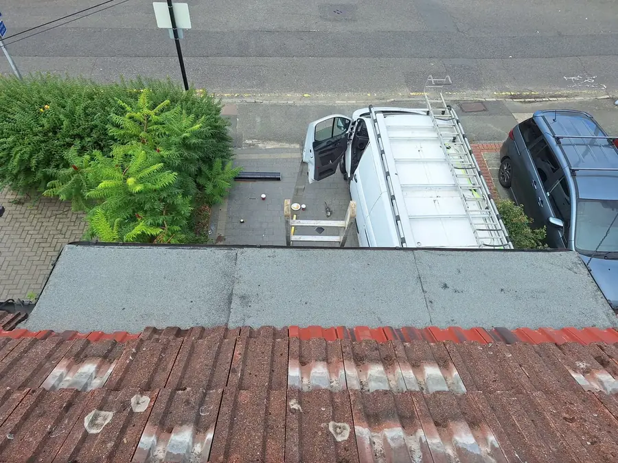 New flat roof above a red tile roof, Prime West van below