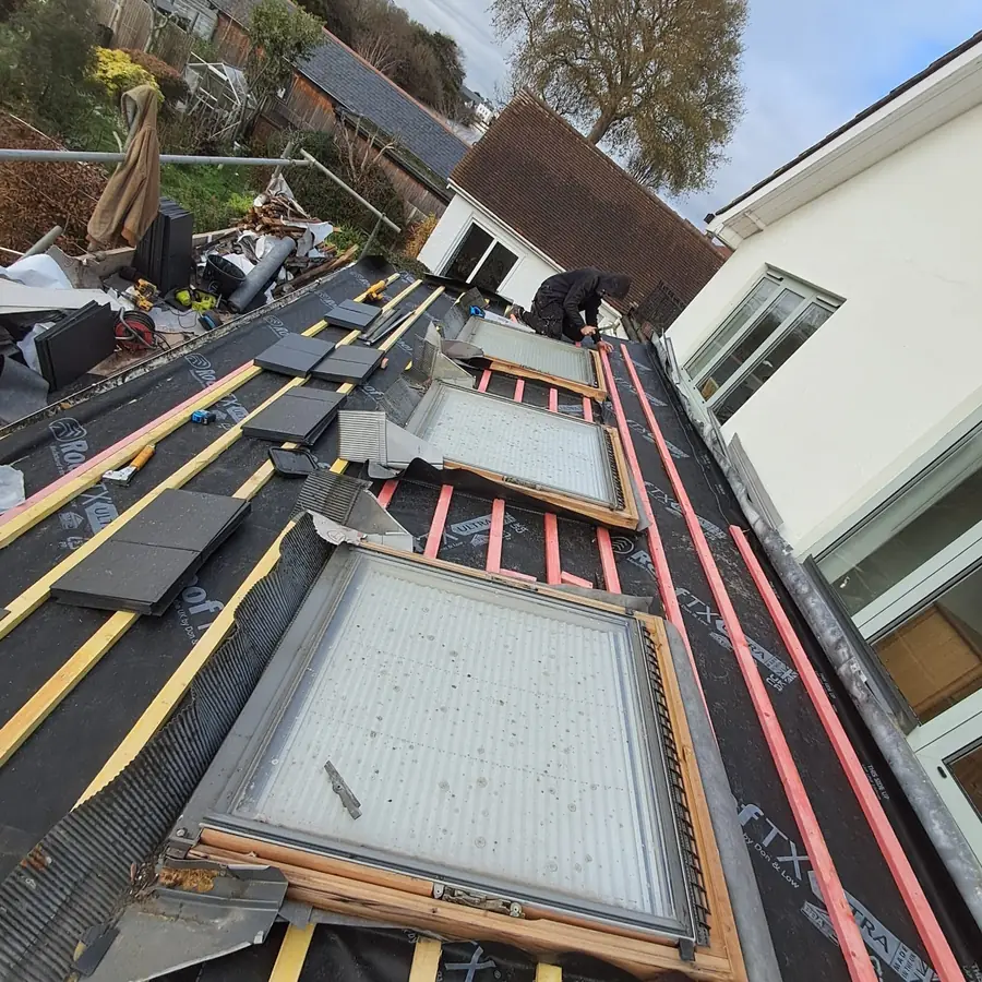 Roof windows framed in with red membrane and battens