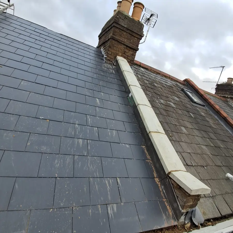 Slate roof with new lead flashing up the chimney