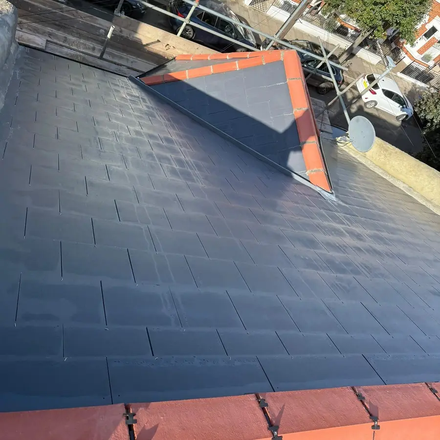 New slate roof finished with an orange clay ridge