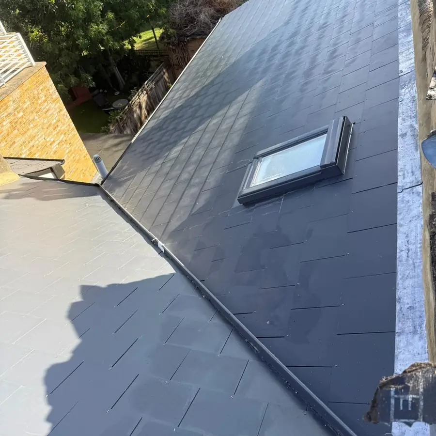 New slate roof with a roof window fitted