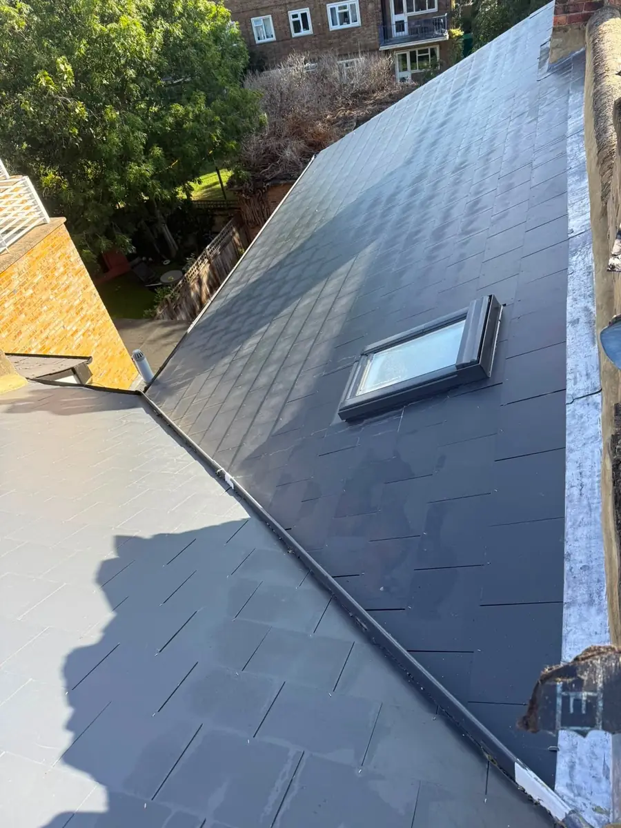 Long slate roof slope with a roof window