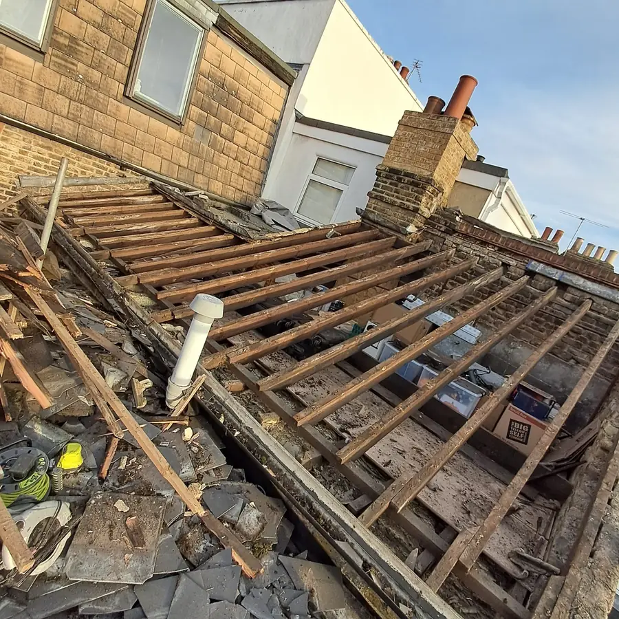 Terrace roof stripped to the rafters beside the next door roof