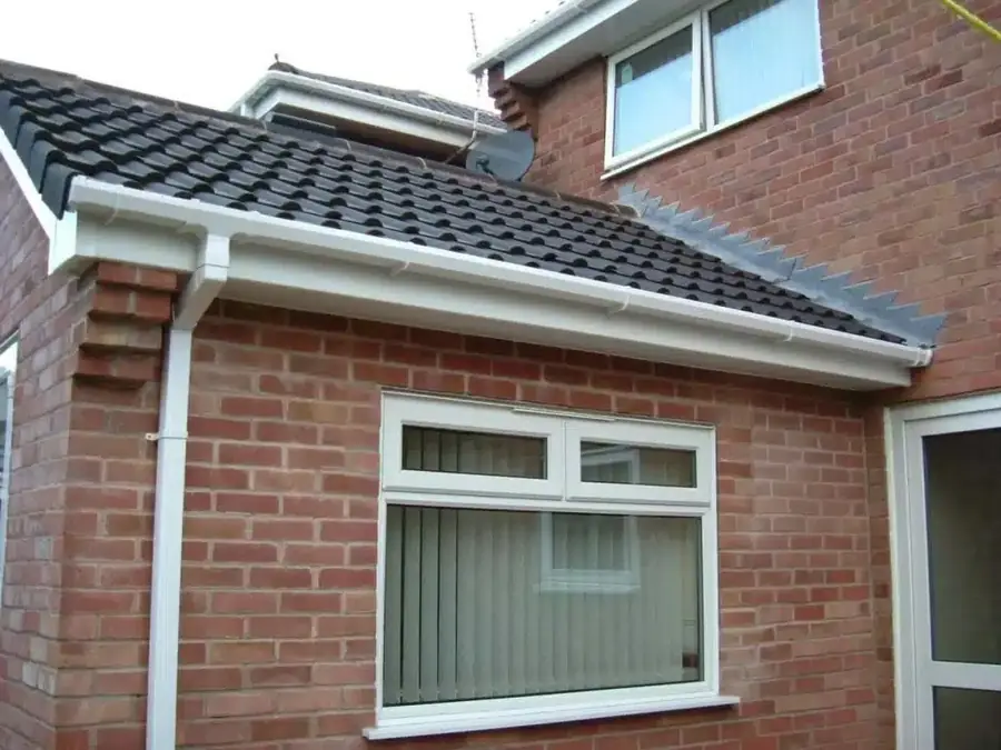 New white fascias and gutters on a brick extension