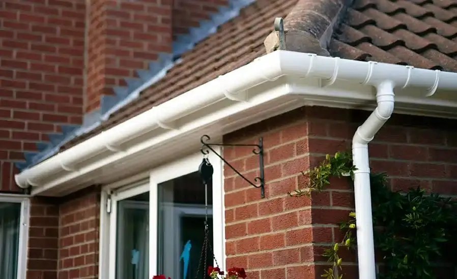 New white fascias and guttering on a brick semi